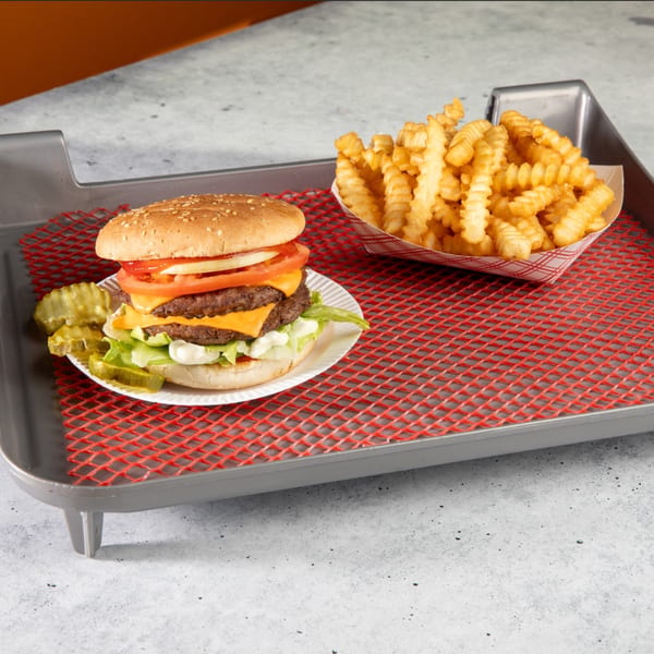 A double cheeseburger with lettuce, tomato, onion, and pickles, served with crinkle-cut fries.