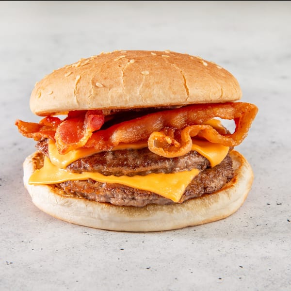 A double bacon cheeseburger from Stewart's Drive-In, with melted cheese and crispy bacon on a sesame bun.